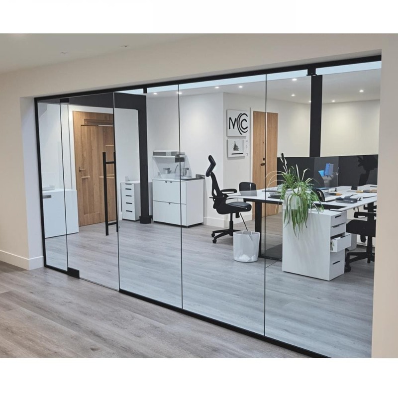 Modern frameless glass partition in office