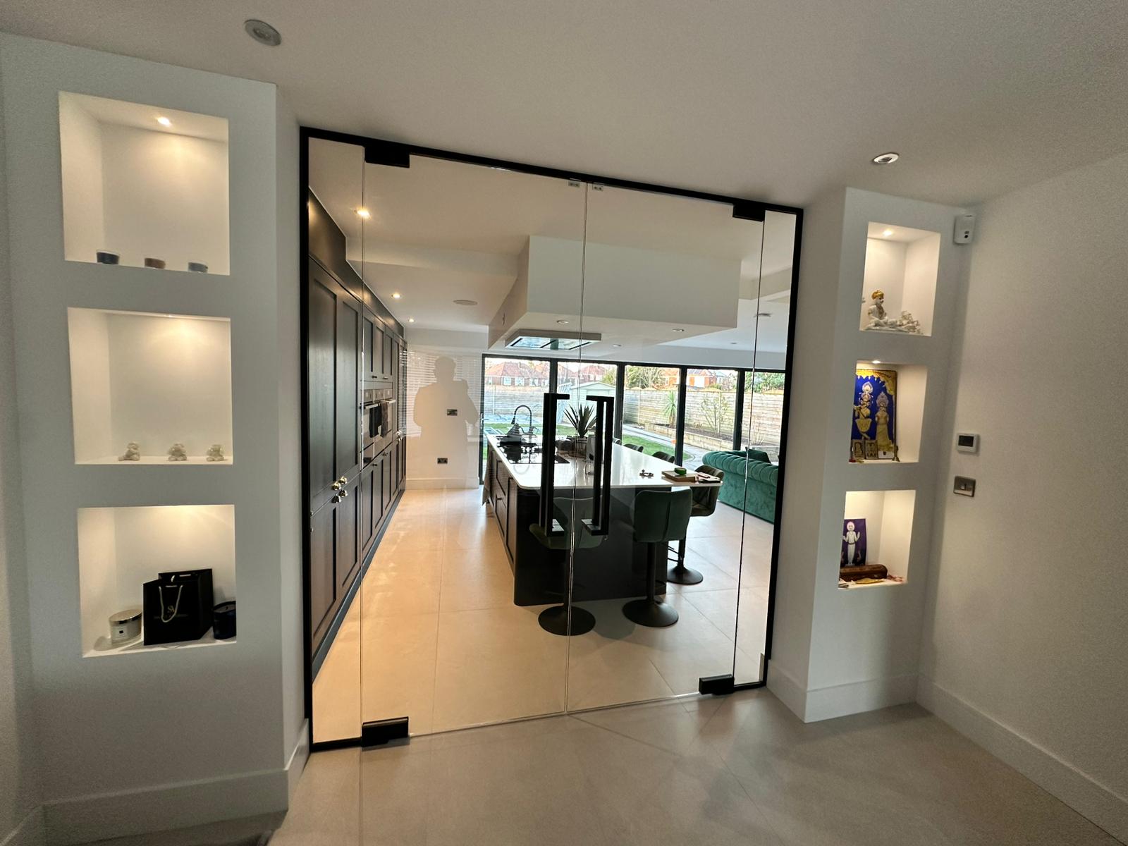 Black channel frameless double glass doors with square pull handles