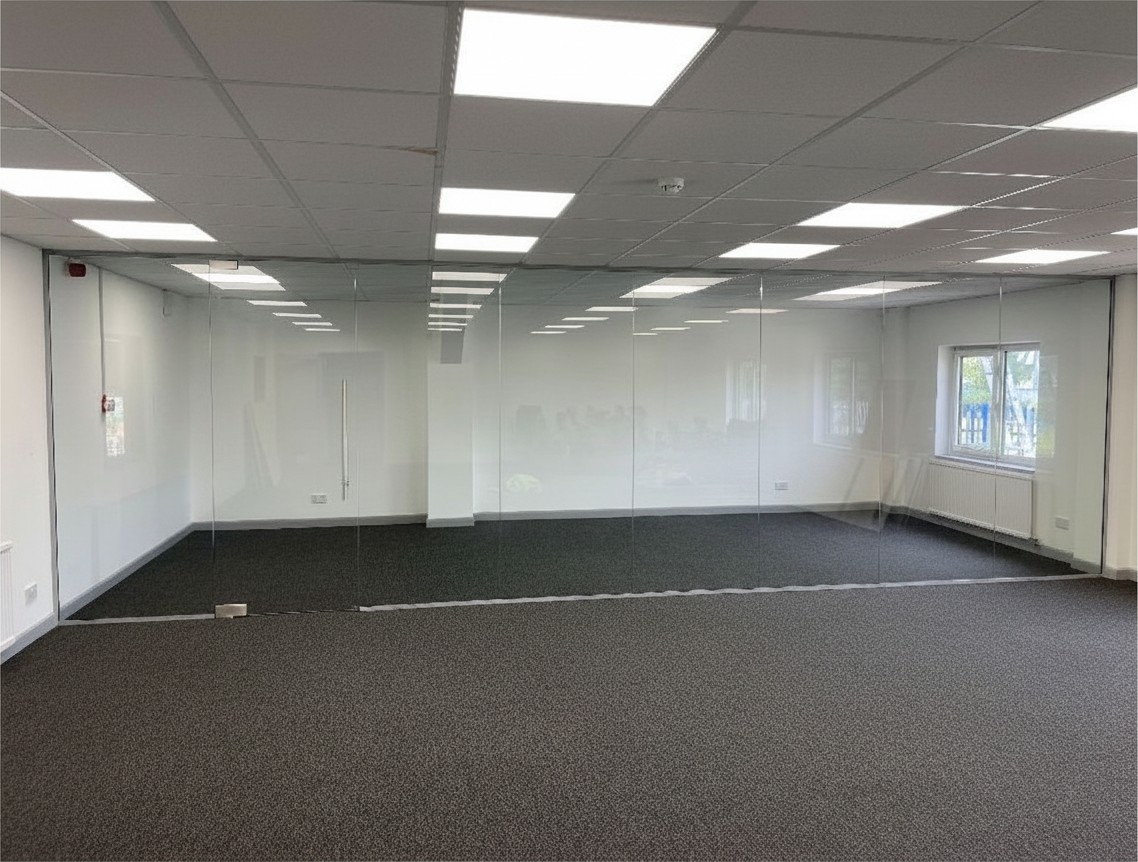 Silver channel office glass partition with a frameless door and pull handle
